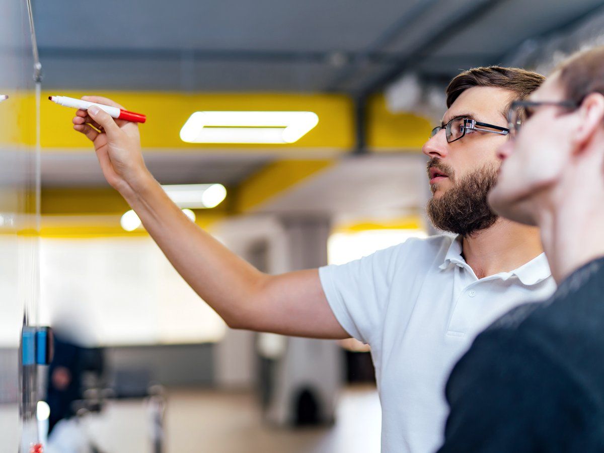 A security advisor mapping out a program plan at a whiteboard