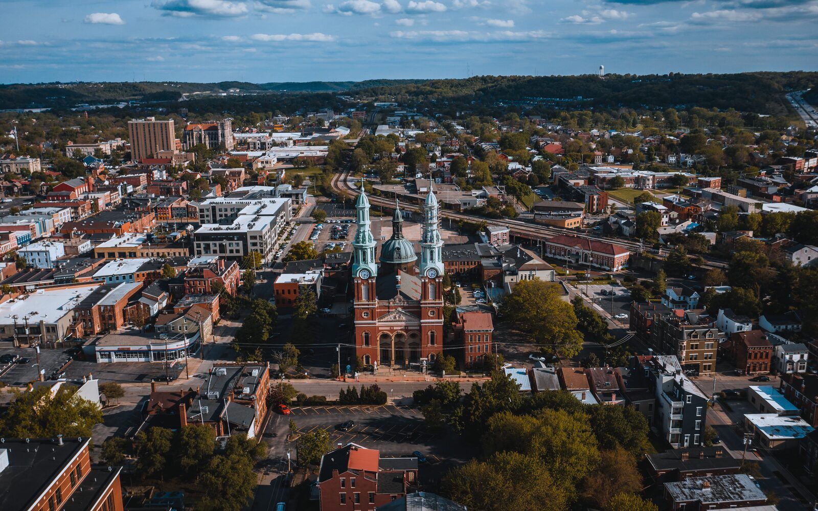 Aerial view of a Kentucky river town with a historic cathedral at its center