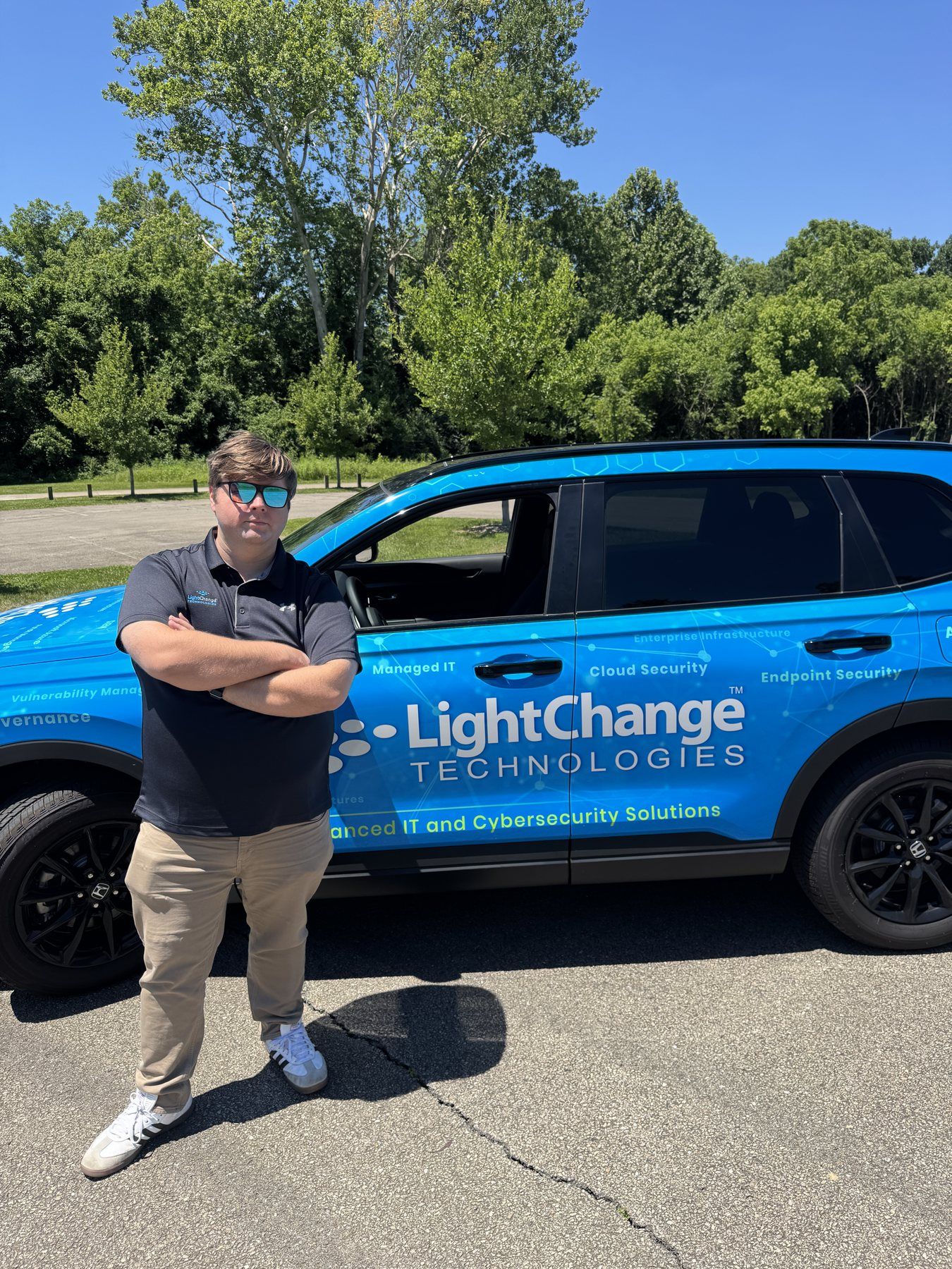 A LightChange team member with a LightChange-wrapped service vehicle.